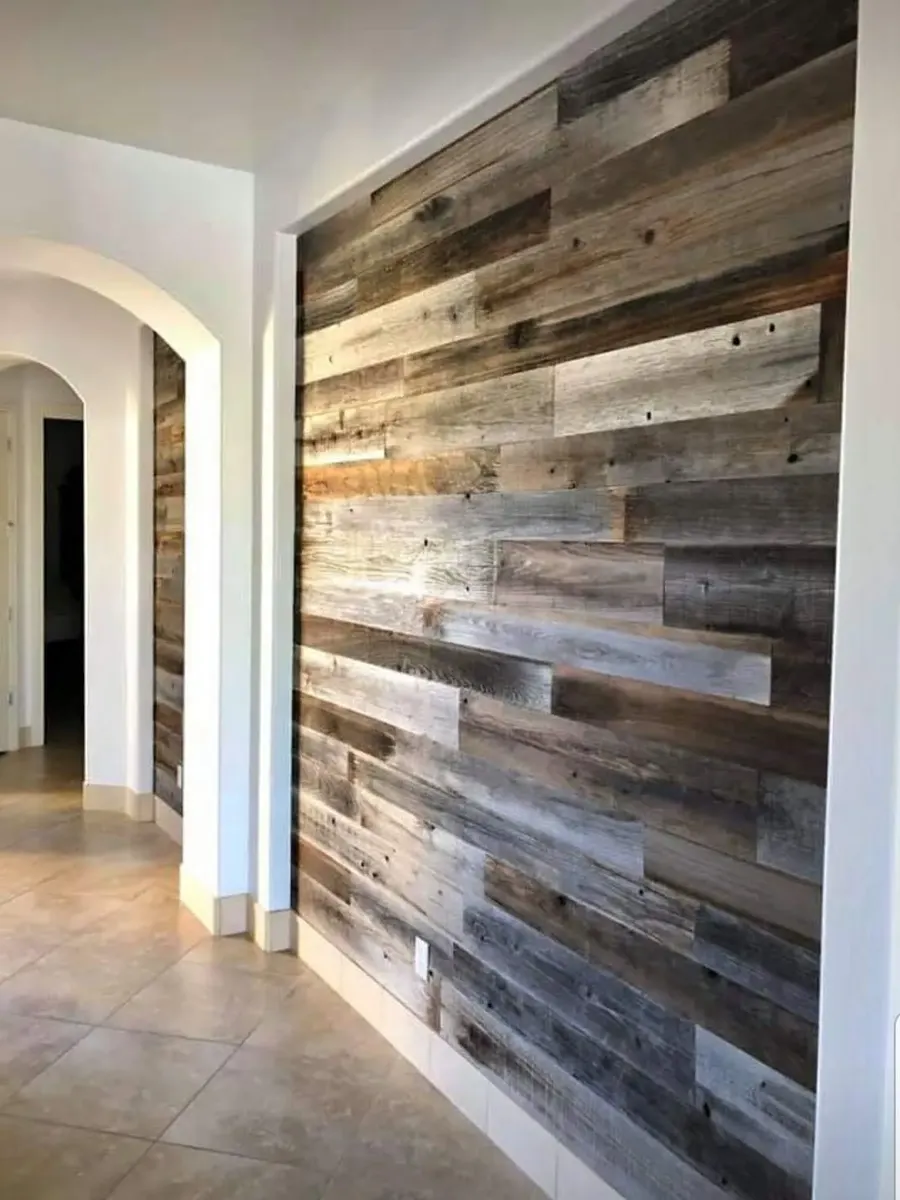 Hallway wall finished with varied reclaimed-wood planks