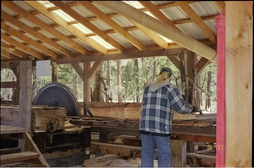 Mill worker running early sawmill equipment at Camas Creek in 2001